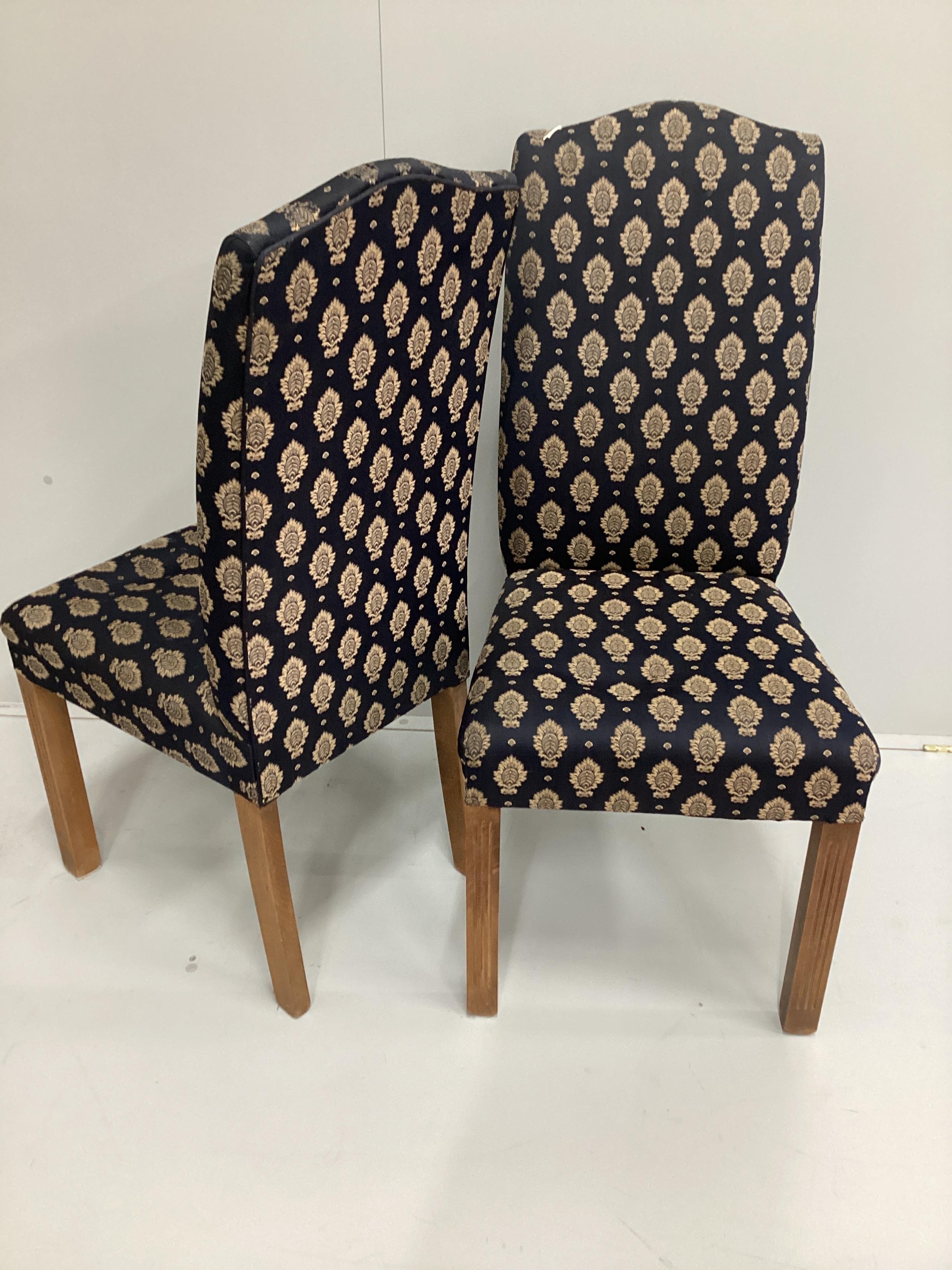 A set of eight George III style upholstered high back dining chairs on fluted square beech legs